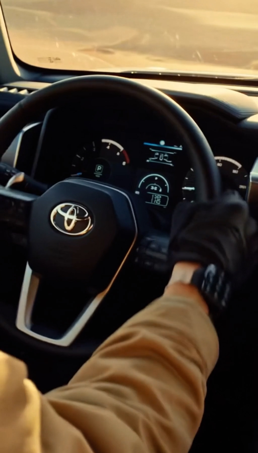Toyota steering wheel and dashboard seen from the driver’s seat in the independent AI automotive concept film.